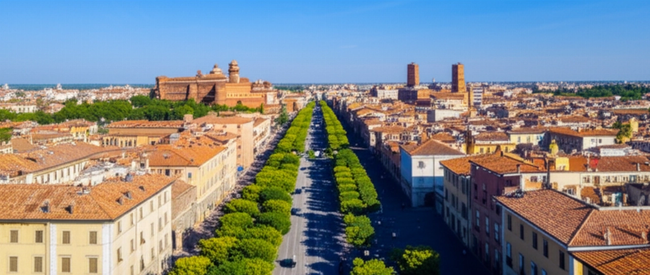 Aerial view of Ferrara with a moving truck driving along tree-lined streets towards the historic center.